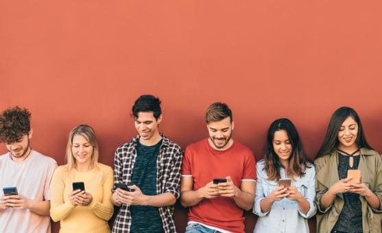 group of students using cell phones in school and college campus